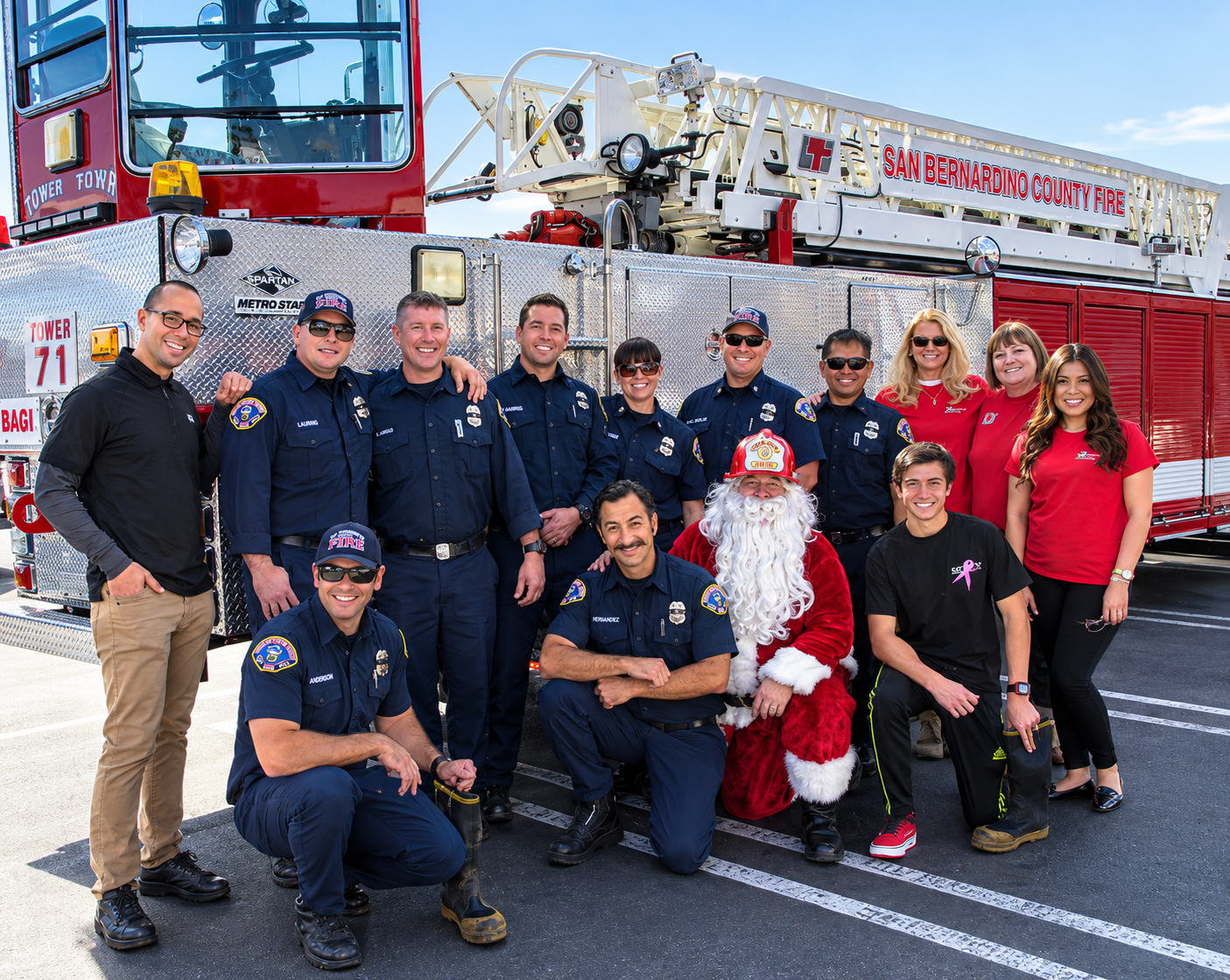 Firefighter handing a gift to a child at the Spark of Love Toy Drive